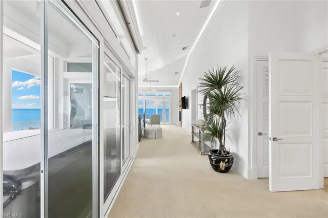 a spacious bedroom with a large bed and glass door