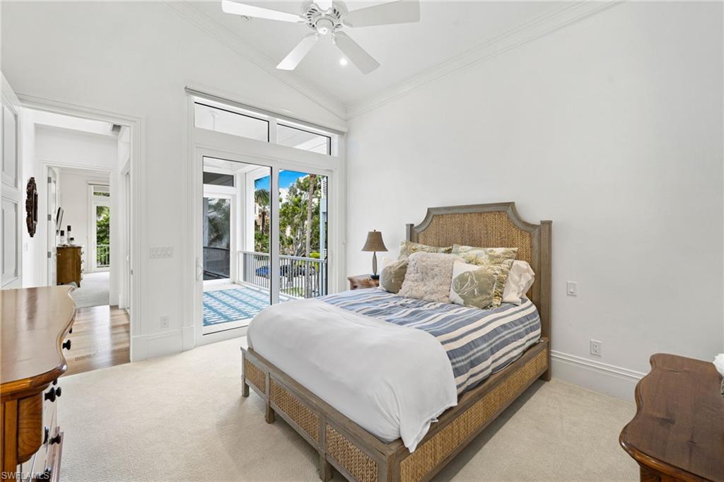 40 32nd Avenue South Naples, FL 34102 - Photo 37 of 49 Bedroom featuring ornamental molding, lofted ceiling, access to outside, multiple windows, and a ceiling fan