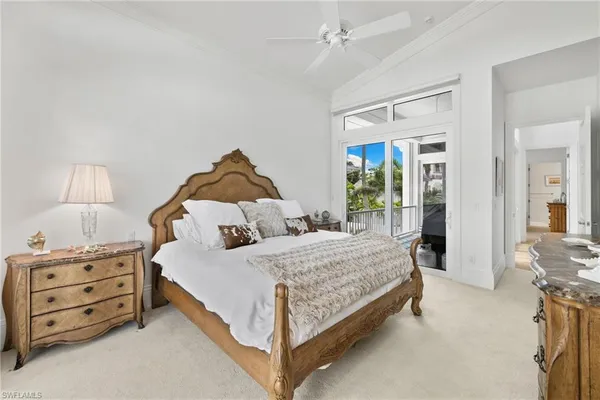 a bedroom with a bed wooden floor and window