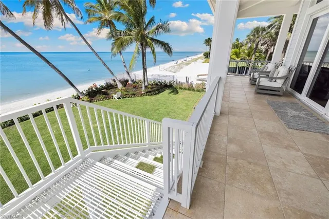 a balcony with table and chairs