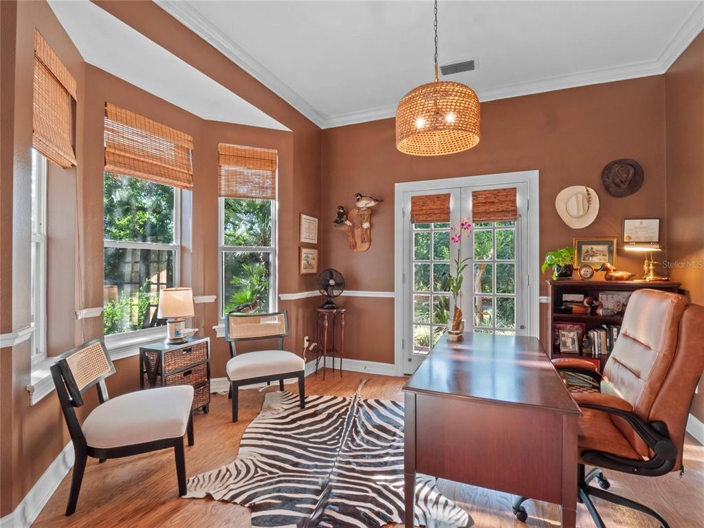 6037 Lake Erie Road Groveland, FL 34736 - Photo 14 of 67 a living room with furniture a fireplace and a large window