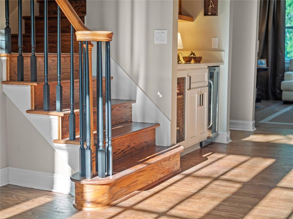 6037 Lake Erie Road Groveland, FL 34736 - Photo 15 of 67 a view of staircase with white walls and railing next to a window