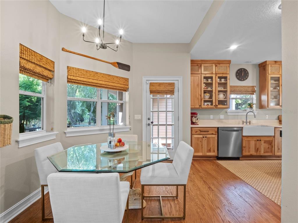 6037 Lake Erie Road Groveland, FL 34736 - Photo 26 of 67 a living room with kitchen island granite countertop furniture a chandelier a large window and appliances