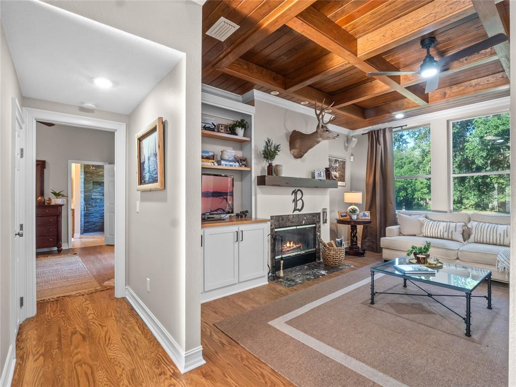 6037 Lake Erie Road Groveland, FL 34736 - Photo 30 of 67 a living room with furniture and a open kitchen view