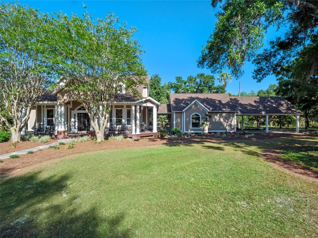 6037 Lake Erie Road Groveland, FL 34736 - Photo 3 of 67 front view of a house with a patio