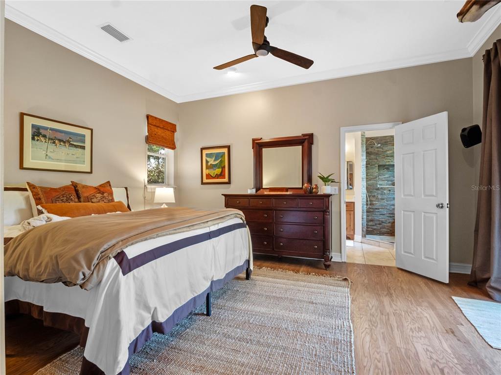 6037 Lake Erie Road Groveland, FL 34736 - Photo 32 of 67 a bedroom with a bed and a dresser