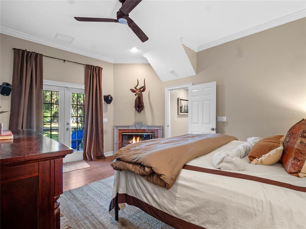 6037 Lake Erie Road Groveland, FL 34736 - Photo 34 of 67 a bedroom with a bed and wooden floor