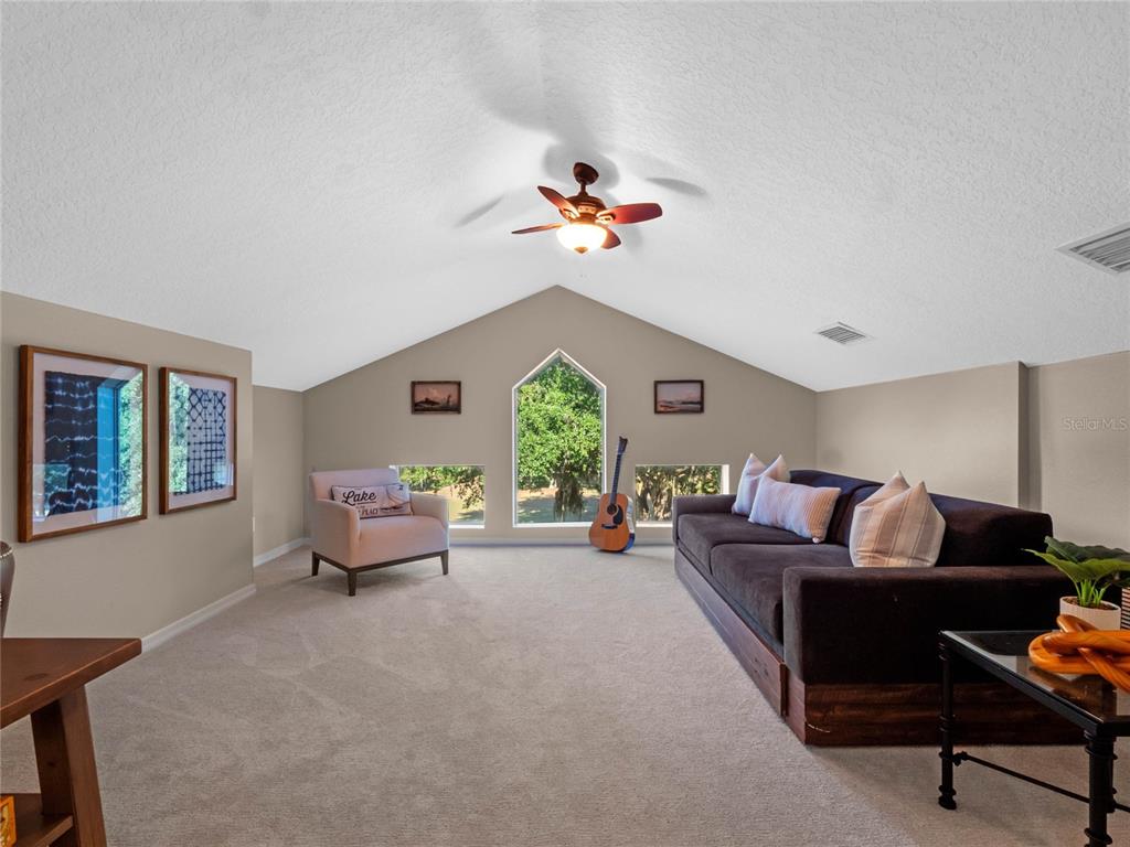 6037 Lake Erie Road Groveland, FL 34736 - Photo 37 of 67 a living room with furniture and a window
