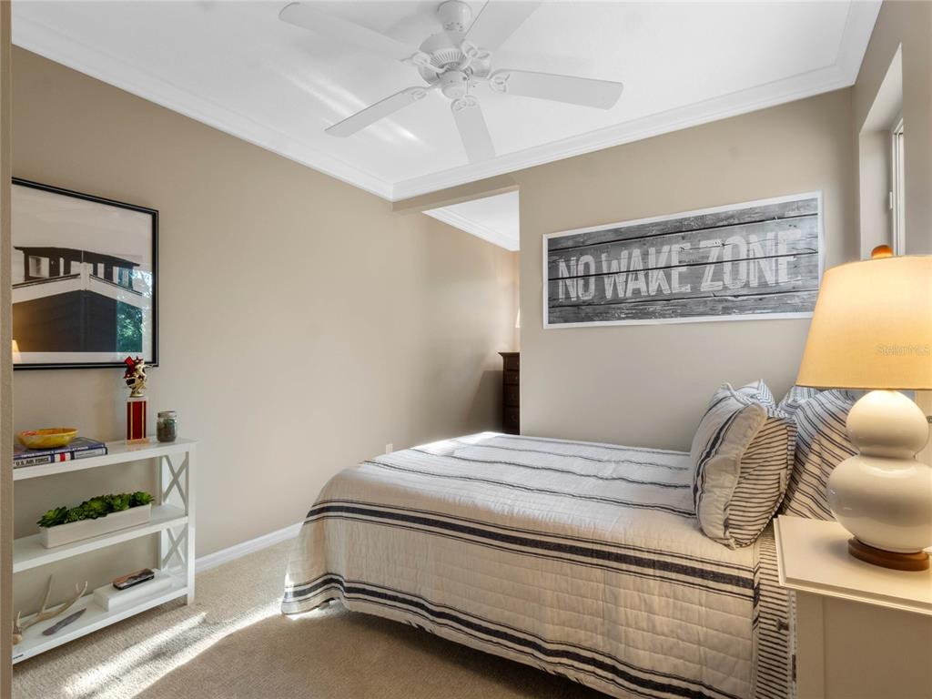 6037 Lake Erie Road Groveland, FL 34736 - Photo 39 of 67 a bedroom with a bed and furniture