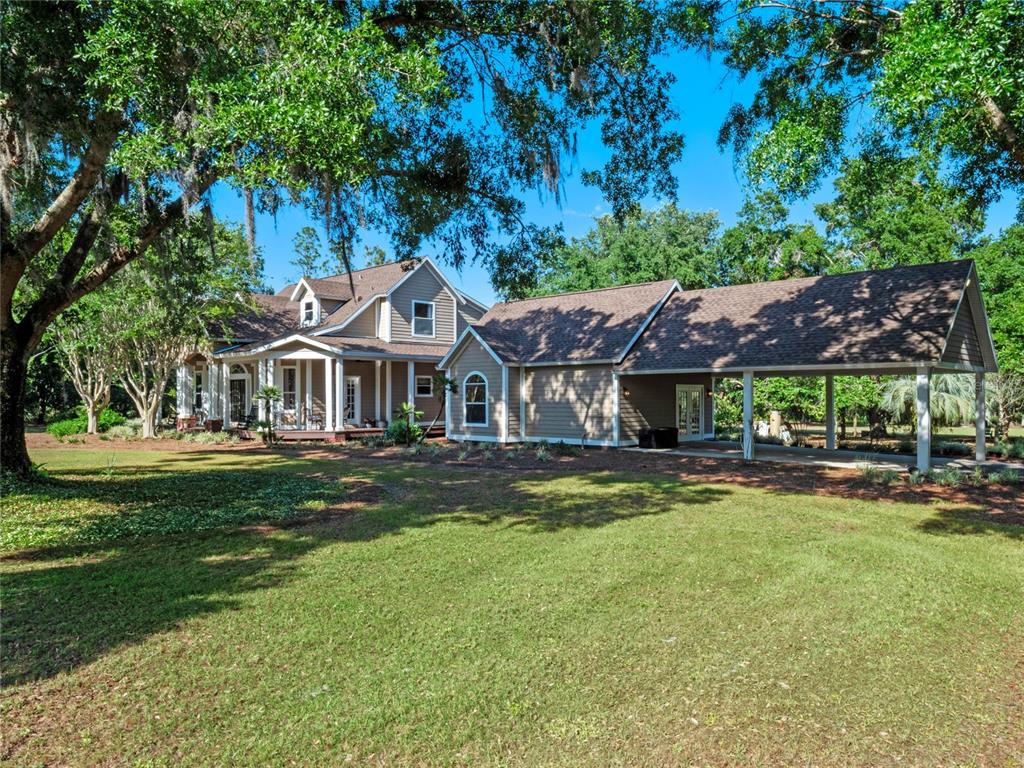 6037 Lake Erie Road Groveland, FL 34736 - Photo 4 of 67 a front view of a house with a garden