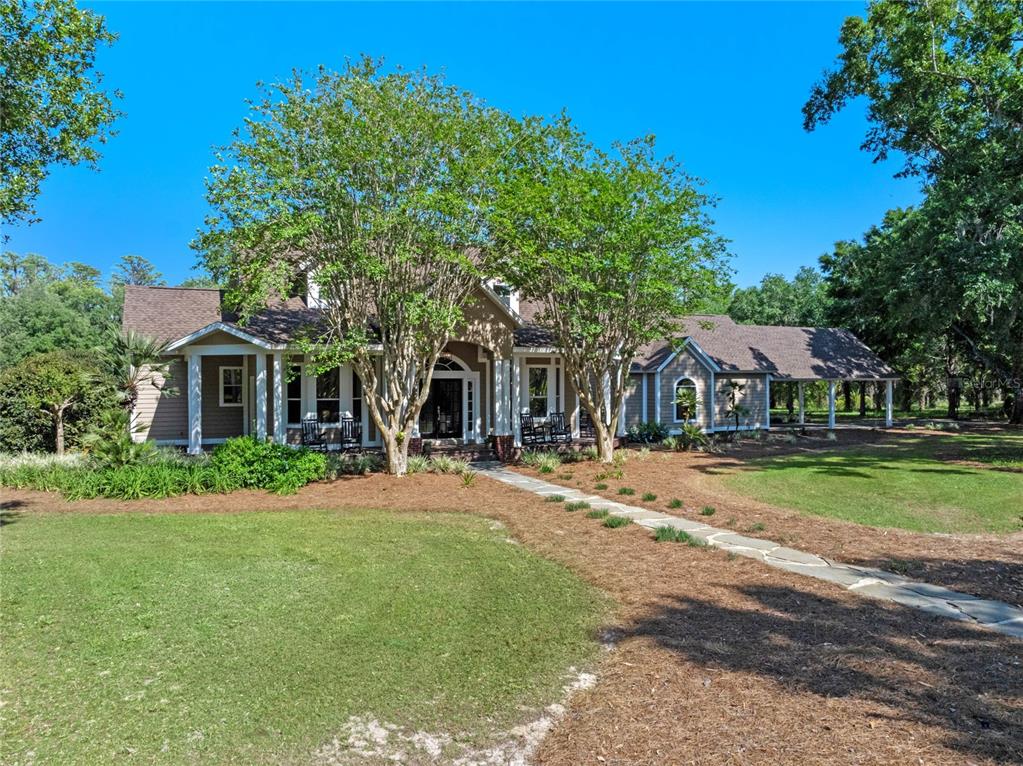 6037 Lake Erie Road Groveland, FL 34736 - Photo 55 of 67 a front view of a house with a yard