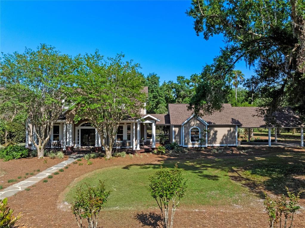6037 Lake Erie Road Groveland, FL 34736 - Photo 63 of 67 a front view of a building with a garden