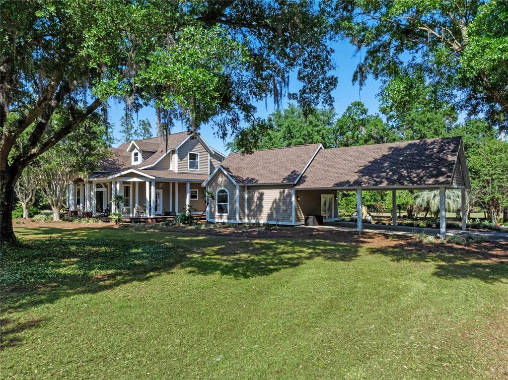 6037 Lake Erie Road Groveland, FL 34736 - Photo 64 of 67 a front view of a house with a garden