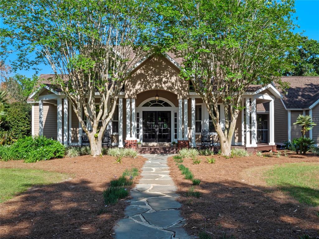 6037 Lake Erie Road Groveland, FL 34736 - Photo 10 of 67 a front view of a house with yard and tress