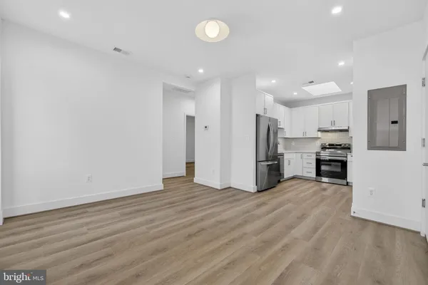 a view of kitchen with stainless steel appliances refrigerator oven and stove