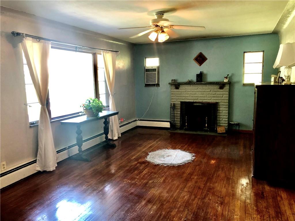 665 Martin Road Belle Vernon, PA 15012 - Photo 4 of 25 Living Room with Freshened Hardwood Floors, Fireplace and Large Window.