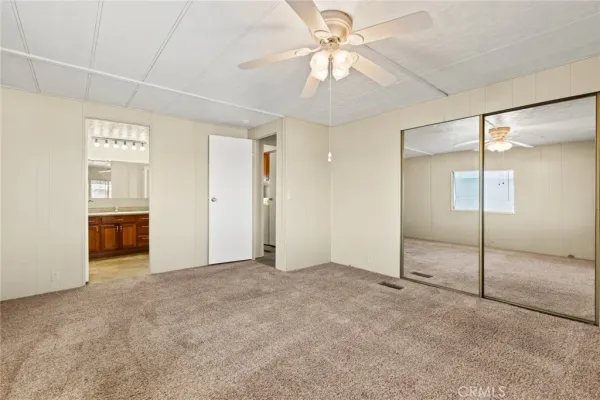 a spacious bathroom with a granite countertop sink toilet and shower