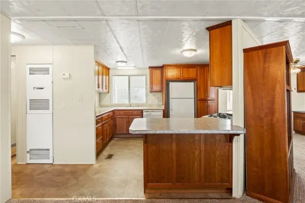 a kitchen with stainless steel appliances granite countertop a stove a refrigerator and a sink