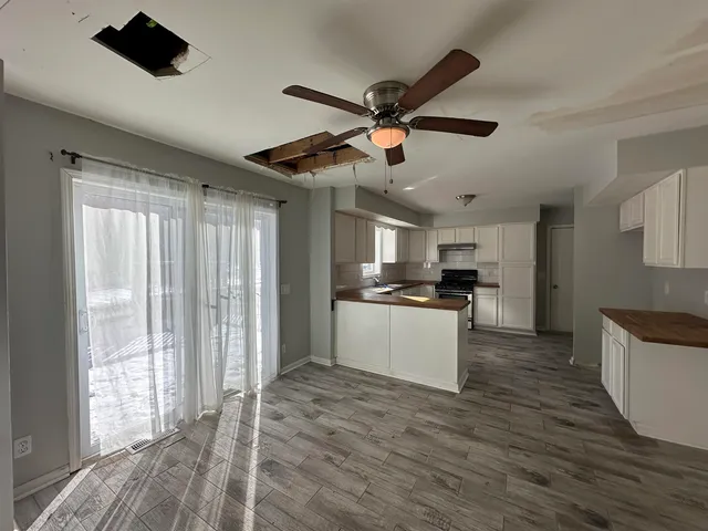 a kitchen with stainless steel appliances kitchen island a sink and a refrigerator