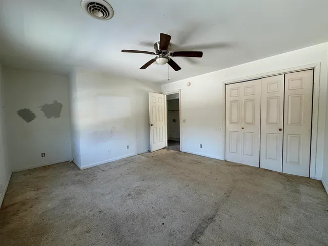 an empty room with closet area