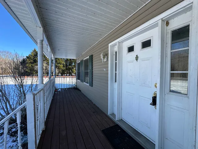 a view of a house with wooden deck