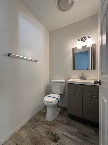 a bathroom with a toilet sink and mirror