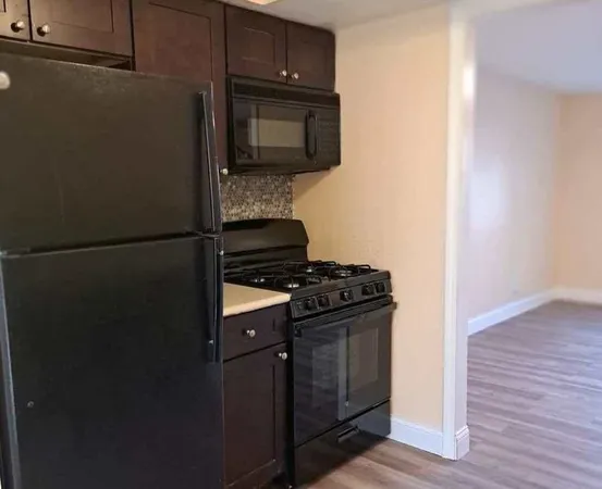 a kitchen with a refrigerator stove and microwave