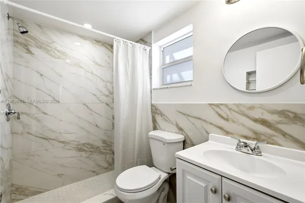 a view of a street with a tree in front of it