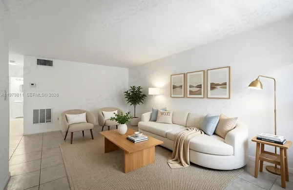 a living room with furniture and a potted plant