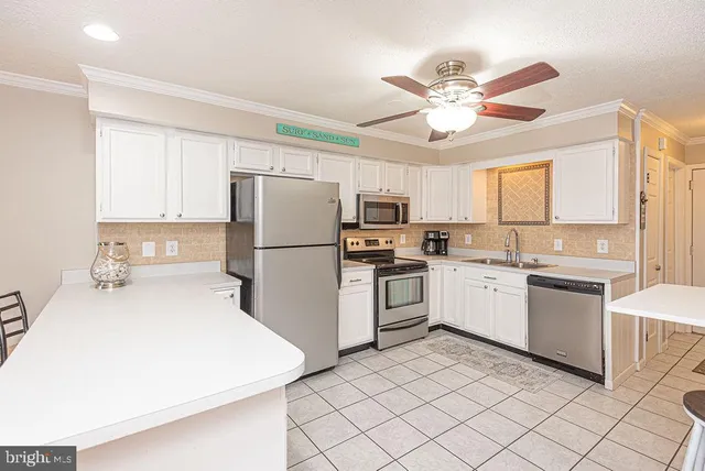a kitchen with white cabinets and white appliances