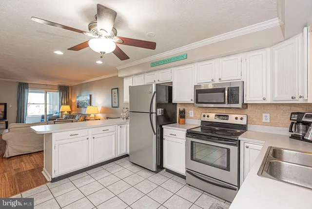a kitchen with white cabinets appliances and sink