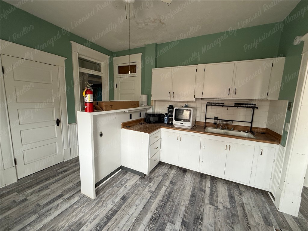 44 West High Street, Unit D Springfield, OH 45502 - Photo 16 of 25 This spacious kitchen offers ample cabinetry and counter space, ideal for culinary pursuits.
