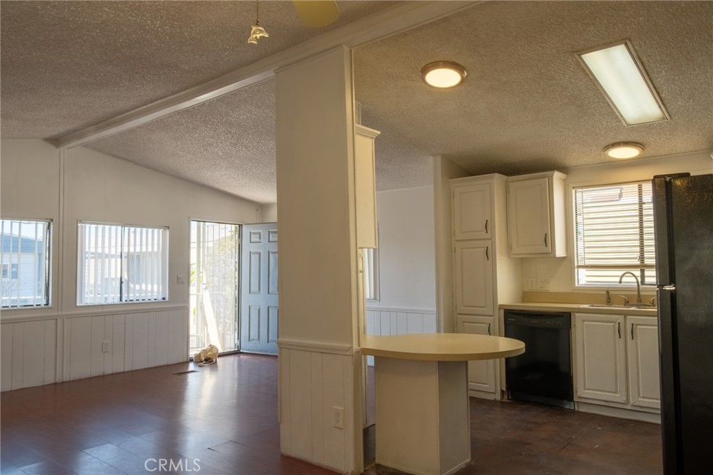 432 South Harbor Boulevard, Unit 7 Santa Ana, CA 92704 - Photo 11 of 35 a view of a kitchen with a sink and dishwasher with wooden floor