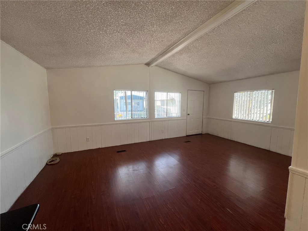 432 South Harbor Boulevard, Unit 7 Santa Ana, CA 92704 - Photo 15 of 35 an empty room with wooden floor and windows