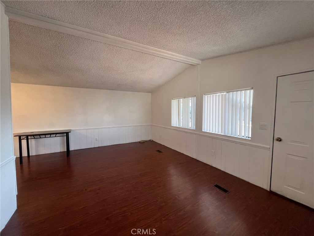 432 South Harbor Boulevard, Unit 7 Santa Ana, CA 92704 - Photo 16 of 35 an empty room with wooden floor and windows