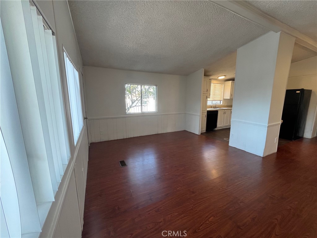 432 South Harbor Boulevard, Unit 7 Santa Ana, CA 92704 - Photo 18 of 35 an empty room with wooden floor and windows