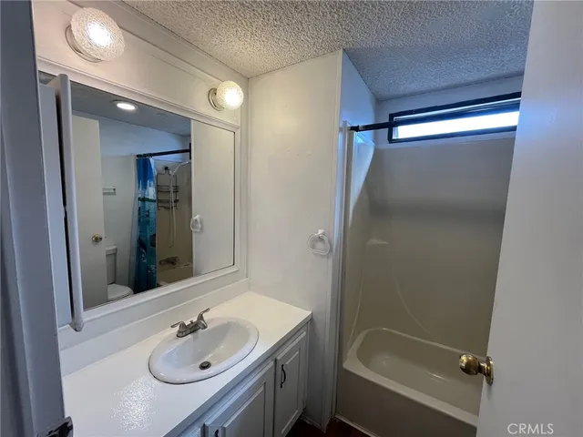 a bathroom with a sink vanity and mirror