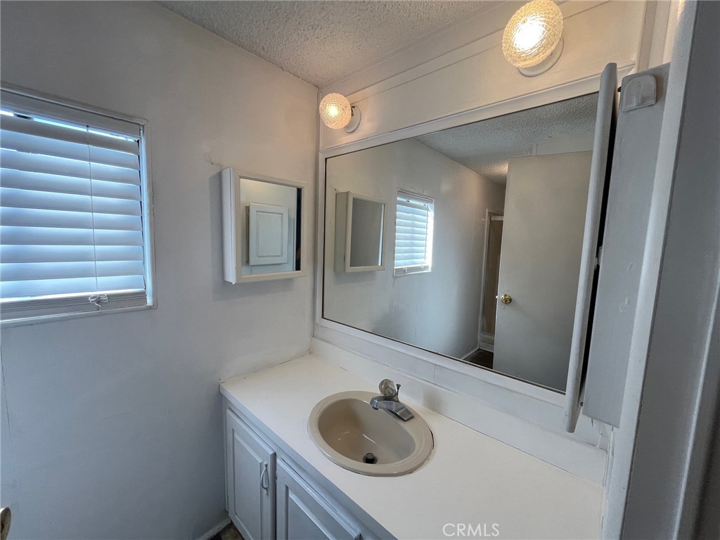432 South Harbor Boulevard, Unit 7 Santa Ana, CA 92704 - Photo 24 of 35 a bathroom with a sink vanity and mirror