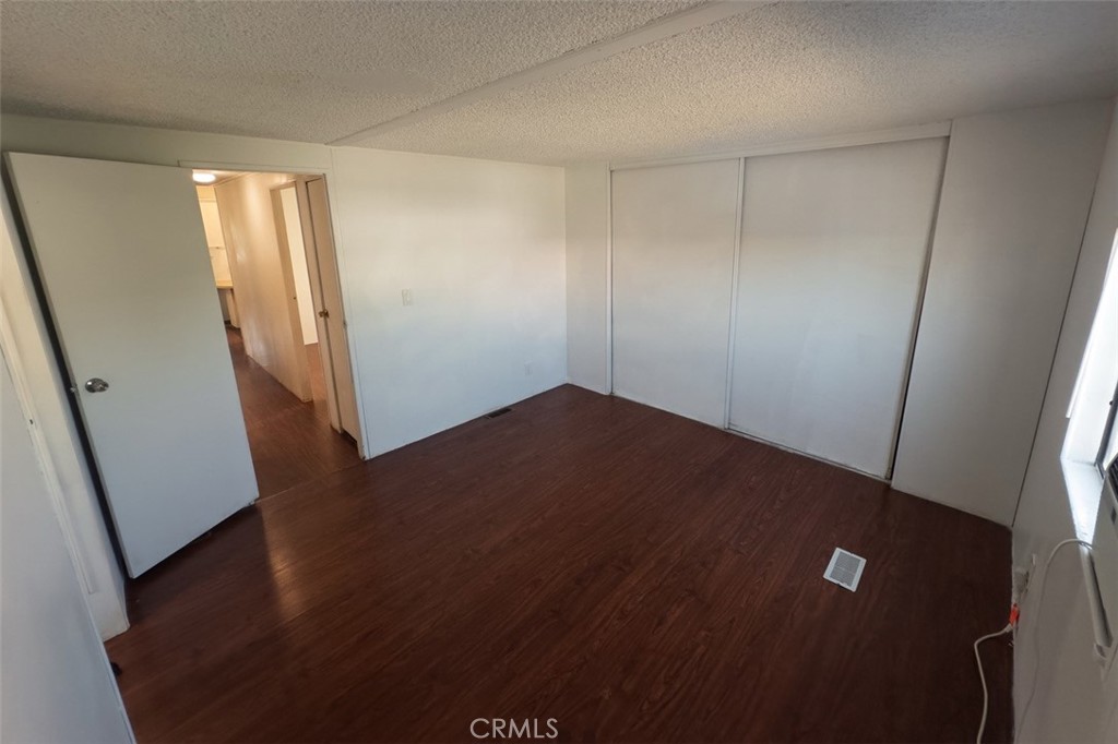432 South Harbor Boulevard, Unit 7 Santa Ana, CA 92704 - Photo 28 of 35 an empty room with wooden floor and windows