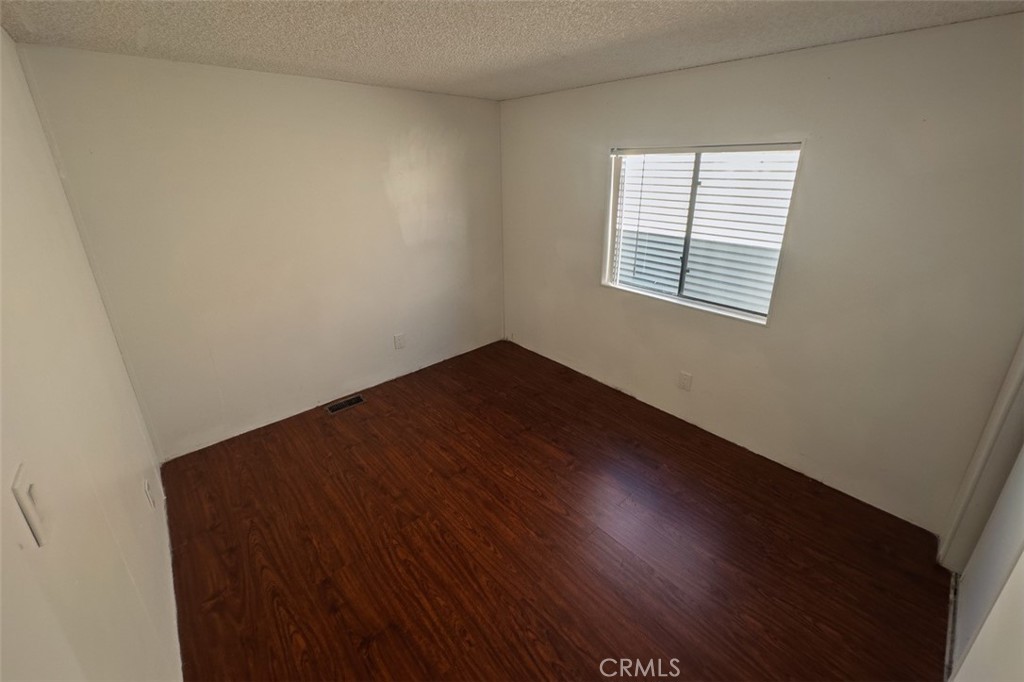 432 South Harbor Boulevard, Unit 7 Santa Ana, CA 92704 - Photo 30 of 35 an empty room with wooden floor and windows