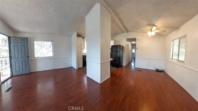 a kitchen with a table chairs refrigerator and cabinets