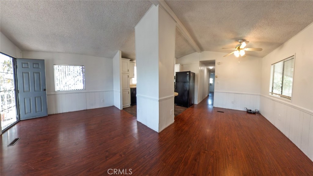 432 South Harbor Boulevard, Unit 7 Santa Ana, CA 92704 - Photo 6 of 35 an empty room with wooden floor and a kitchen