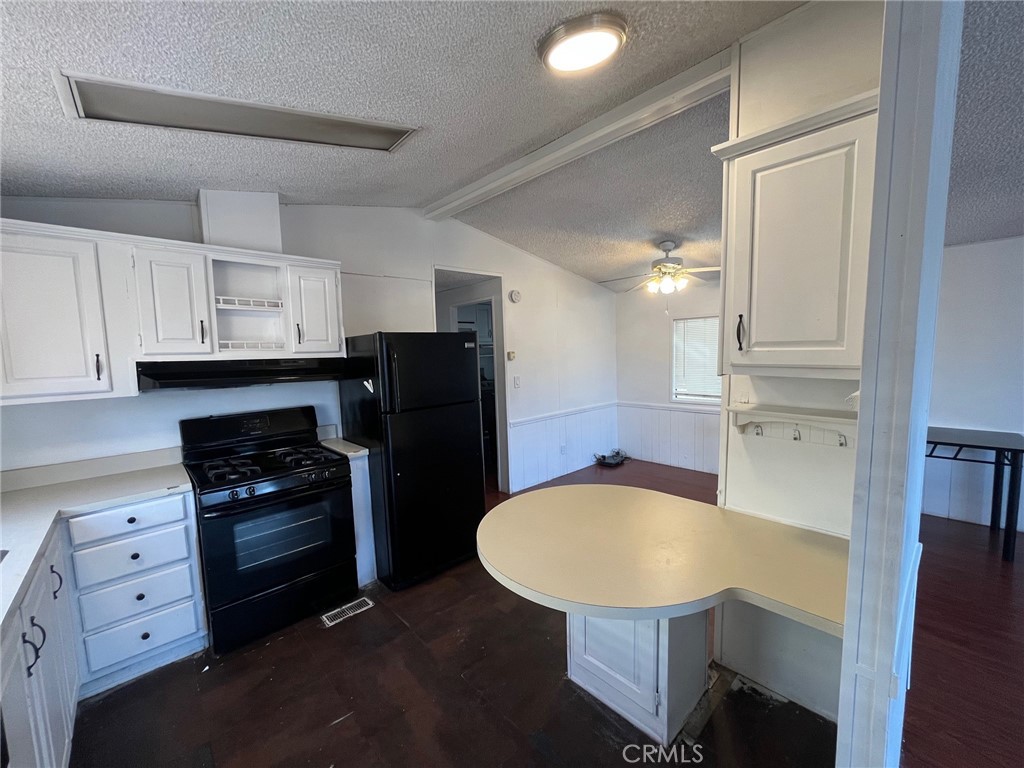 432 South Harbor Boulevard, Unit 7 Santa Ana, CA 92704 - Photo 9 of 35 a kitchen with a table chairs refrigerator and cabinets