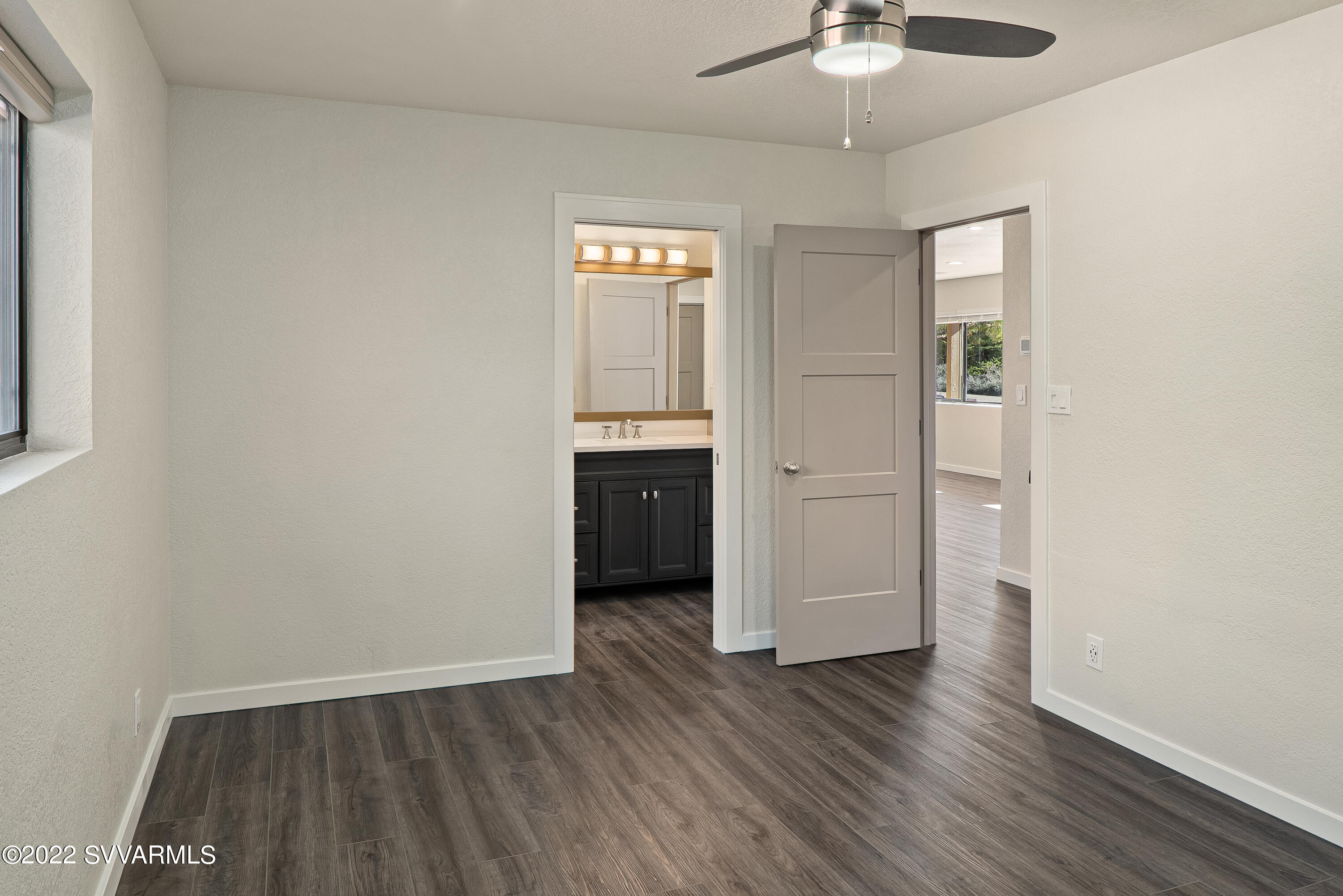 2380 Buckboard Road Sedona, AZ 86336 - Photo 20 of 25 wooden floor in an empty room with a window