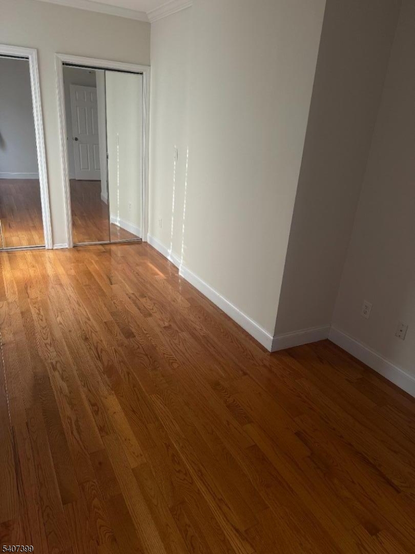 28 Reid Street, Unit 2 Elizabeth, NJ 07201 - Photo 12 of 19 an empty room with wooden floor and entrance