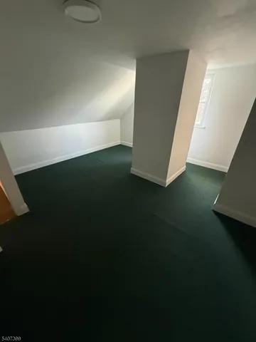 a view of an empty room and kitchen space