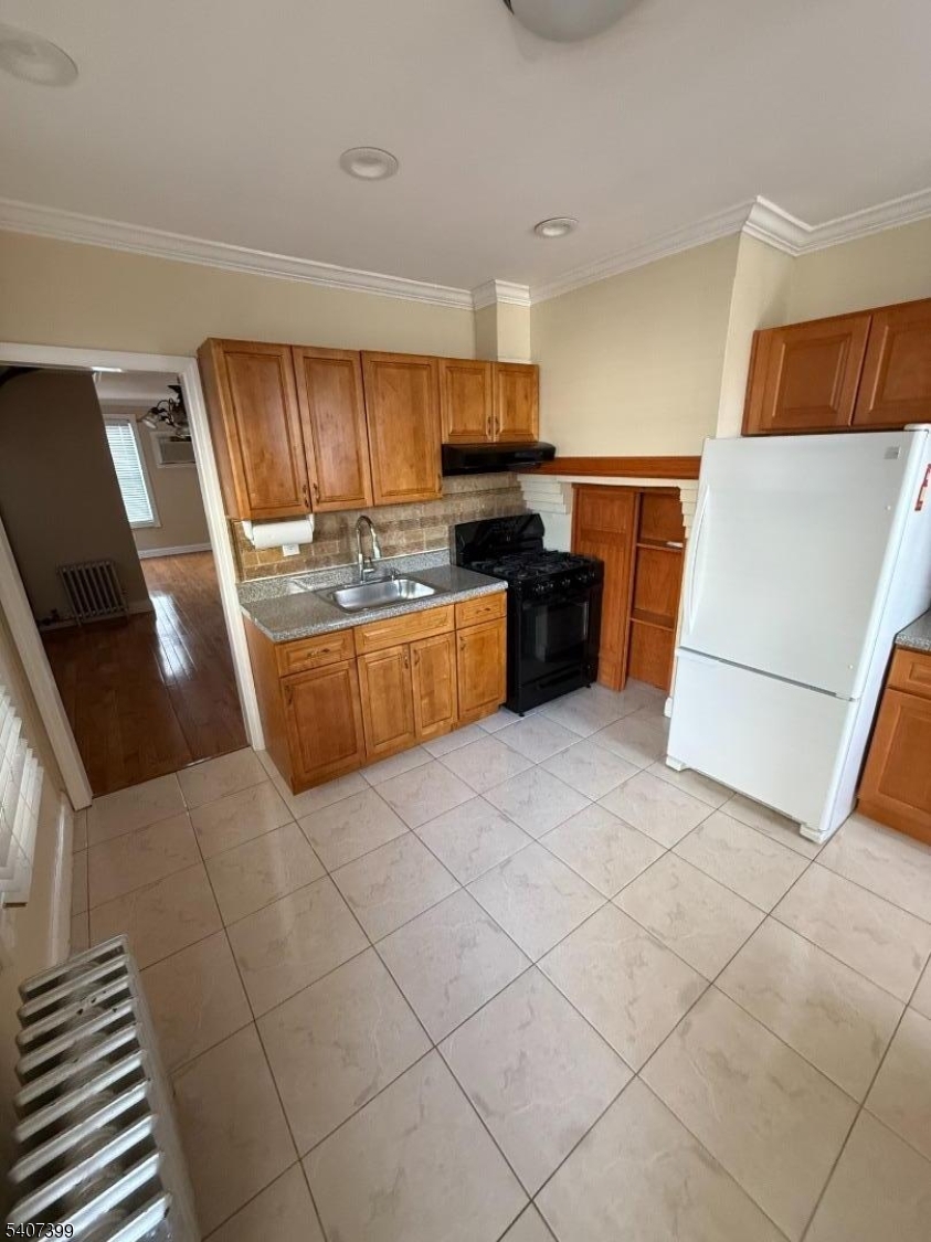 28 Reid Street, Unit 2 Elizabeth, NJ 07201 - Photo 7 of 19 a kitchen with stainless steel appliances granite countertop a refrigerator and a stove