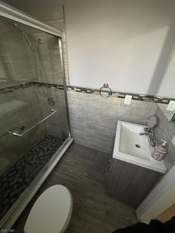 a bathroom with a sink toilet and shower