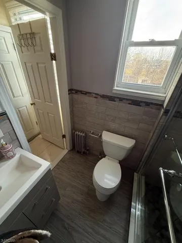 a bathroom with a toilet a sink and a window