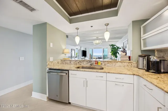 a view of a dining room with furniture and a potted plant